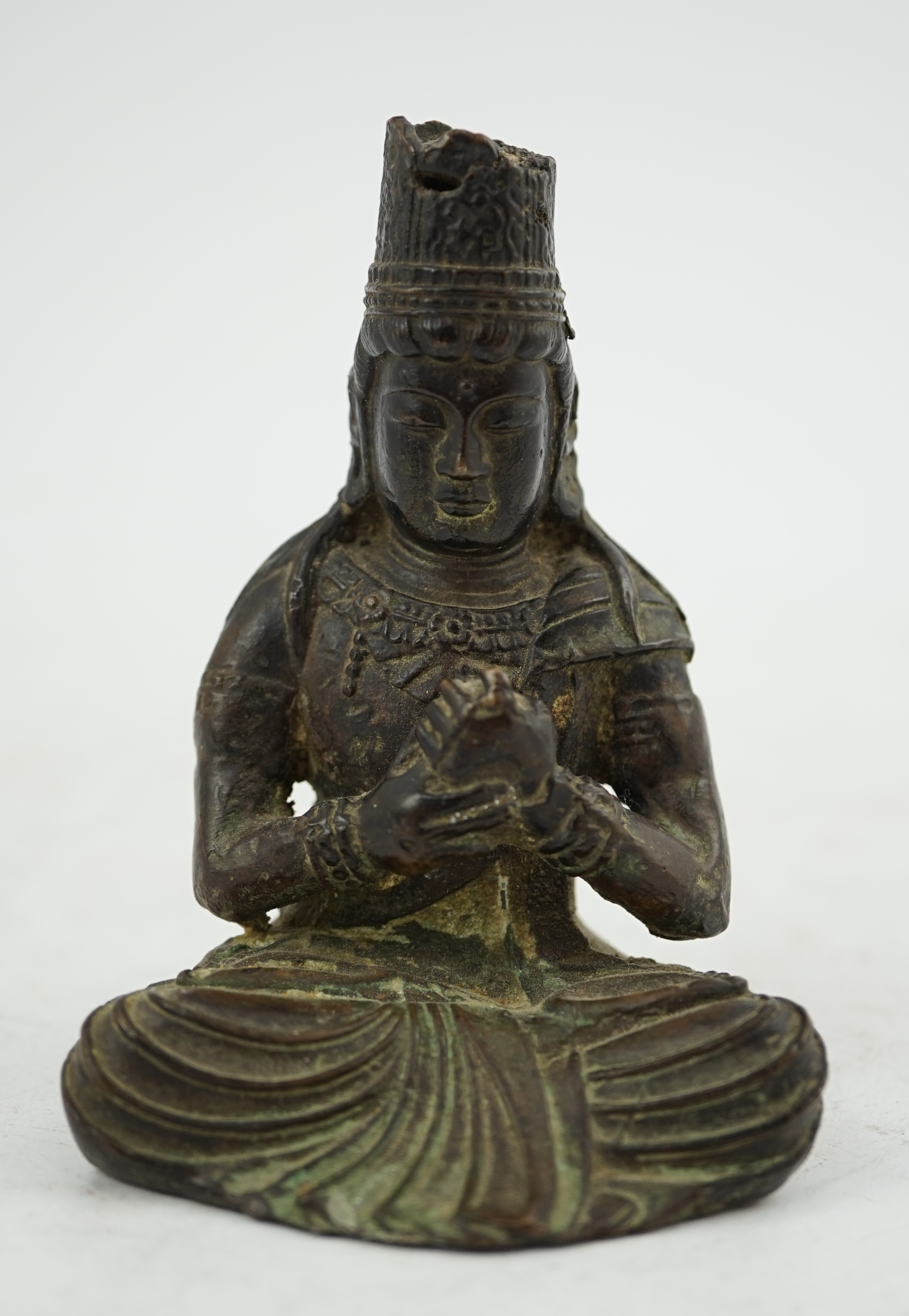 A small South East Asian bronze seated figure of Vairocana Buddha, probably 17th/18th century